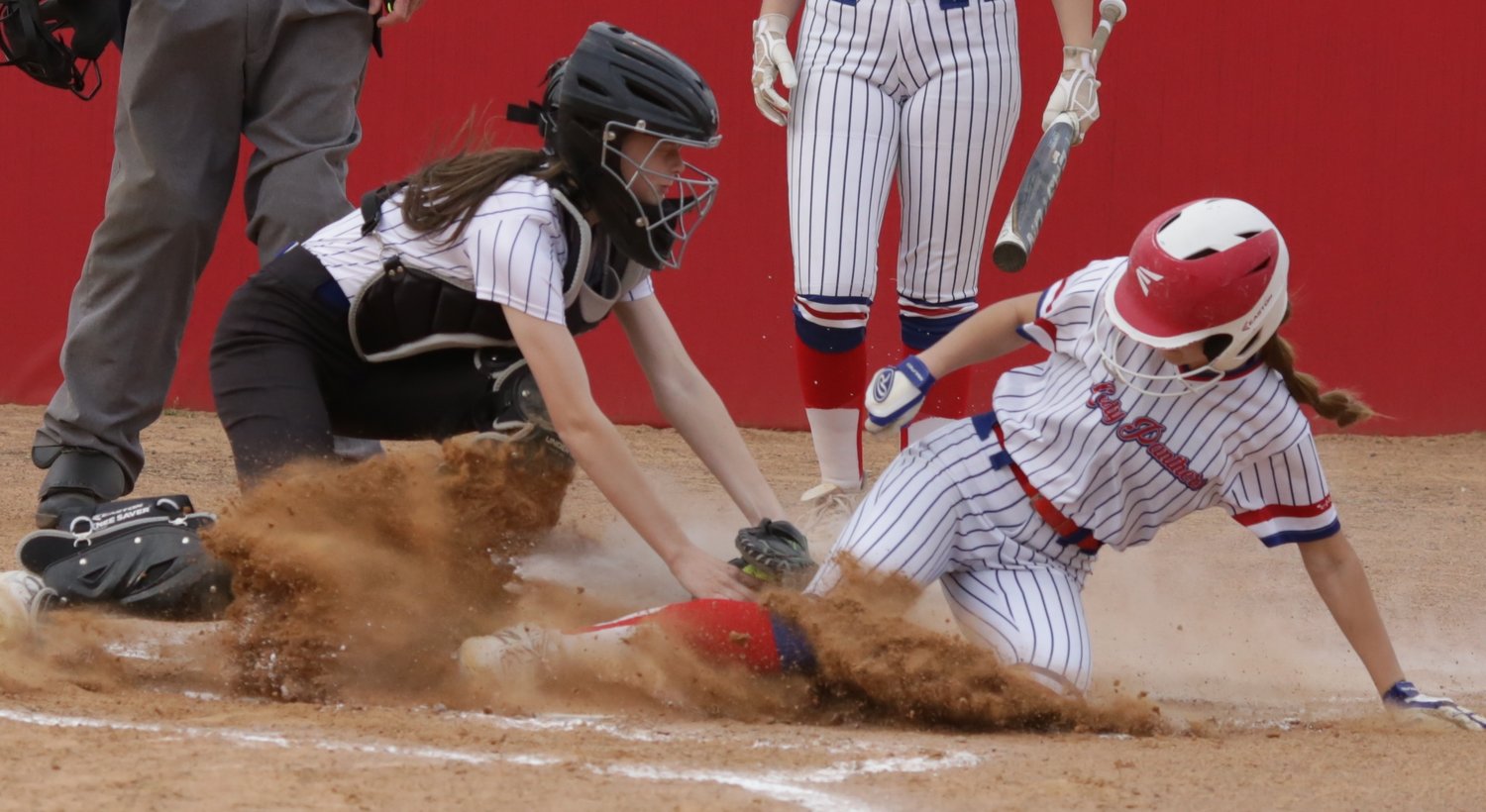 Lady Panther Kalli Trimble gets under the tag as she steals
home to give Alba-Golden their first run of the night against visiting
Sulphur Bluff.